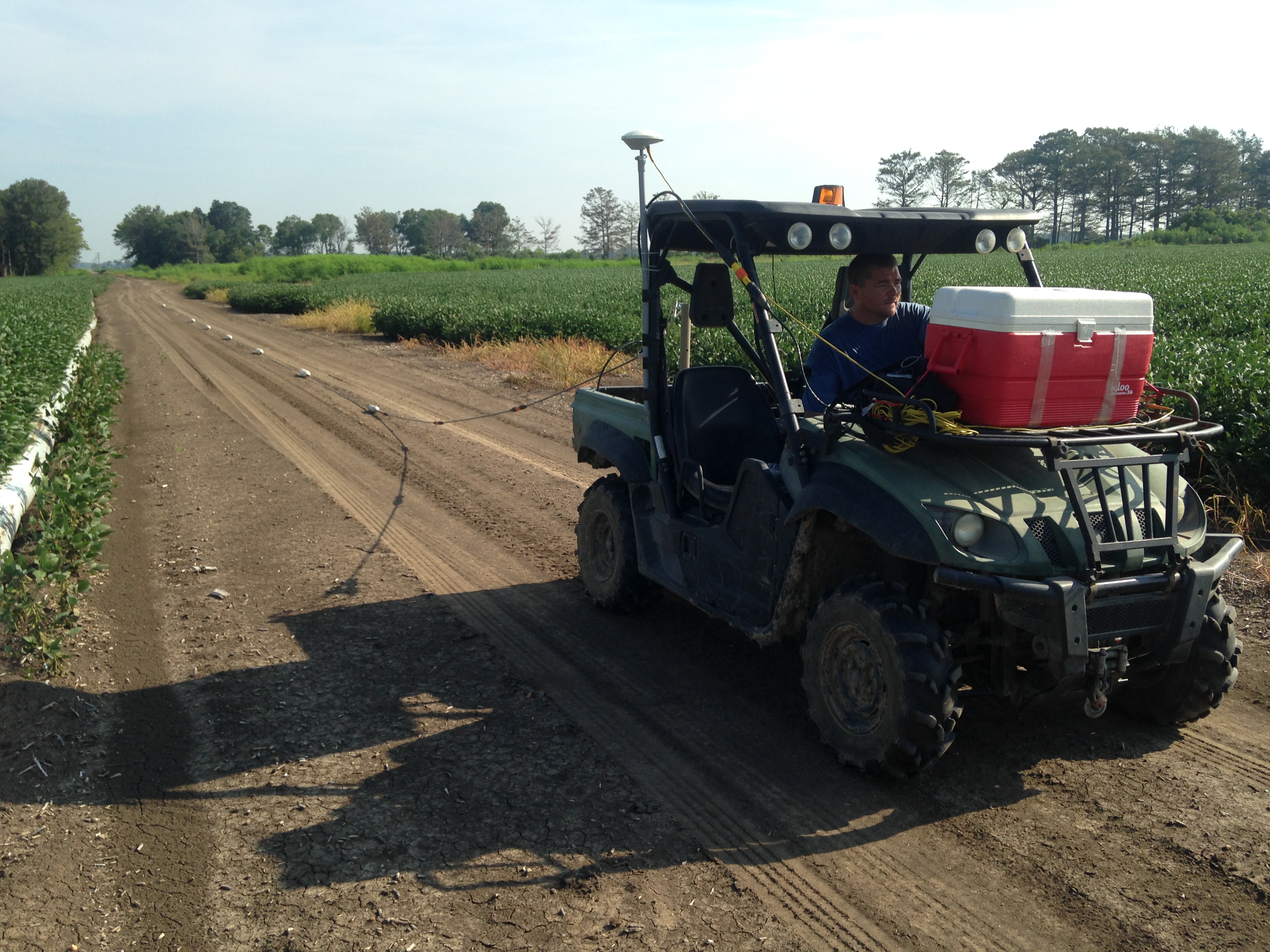 Jason Payne driving an ATV pulling an array of electrodes for mapping the near surface geology in the vicinity of Steiner, MS