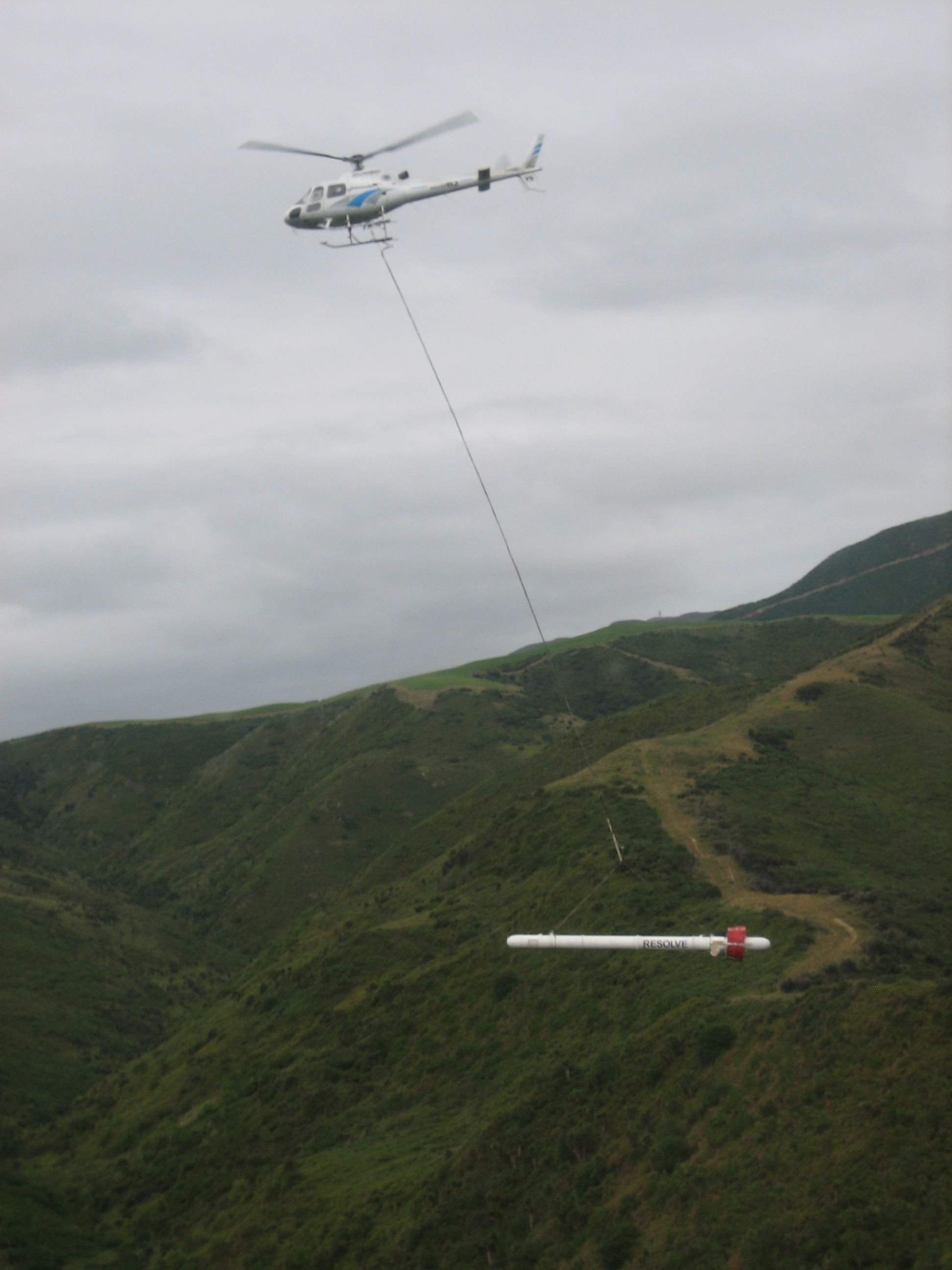 Helicopter collecting geophysical data